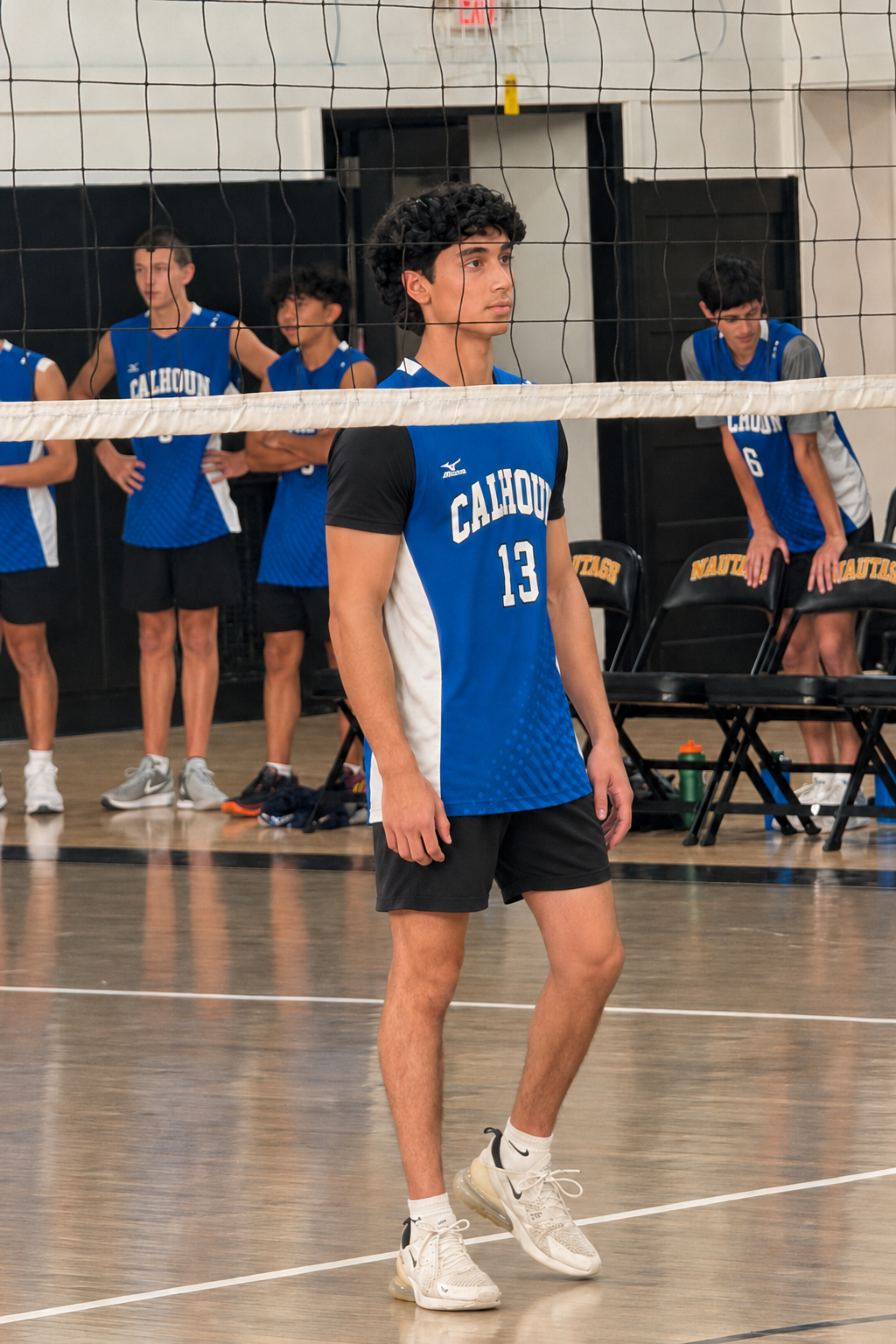 Akif Khan in a Calhoun volleyball jersey at the net during a match