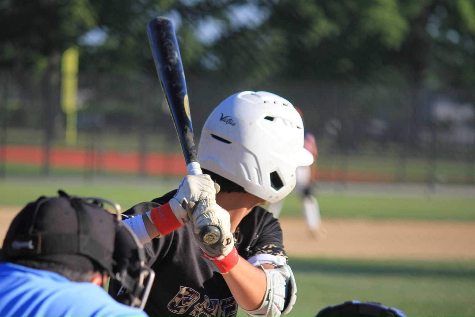 Akif Khan at the plate mid at-bat, bat loaded, during a travel baseball game